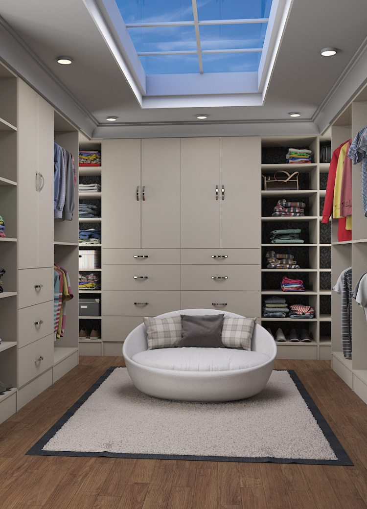 Organized walk-in closet with modular shelving, drawers, and hanging rods in neutral tones.