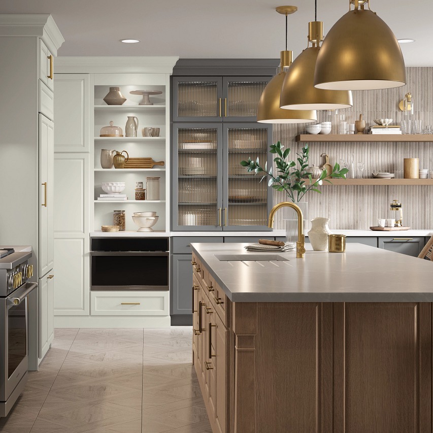 Gold pendant lights in a kitchen with gold hardware and lighted cabinetry