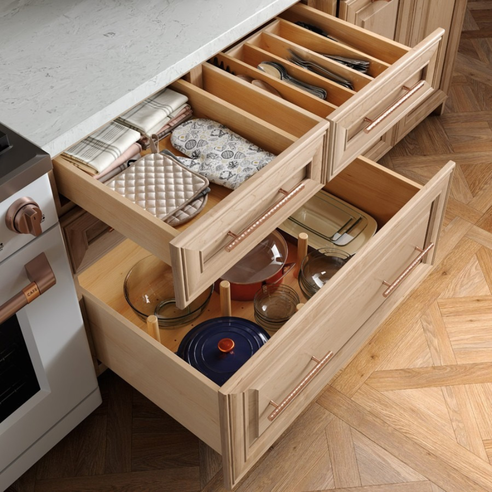 Pull out drawers in a kitchen with utensil and pot organizers